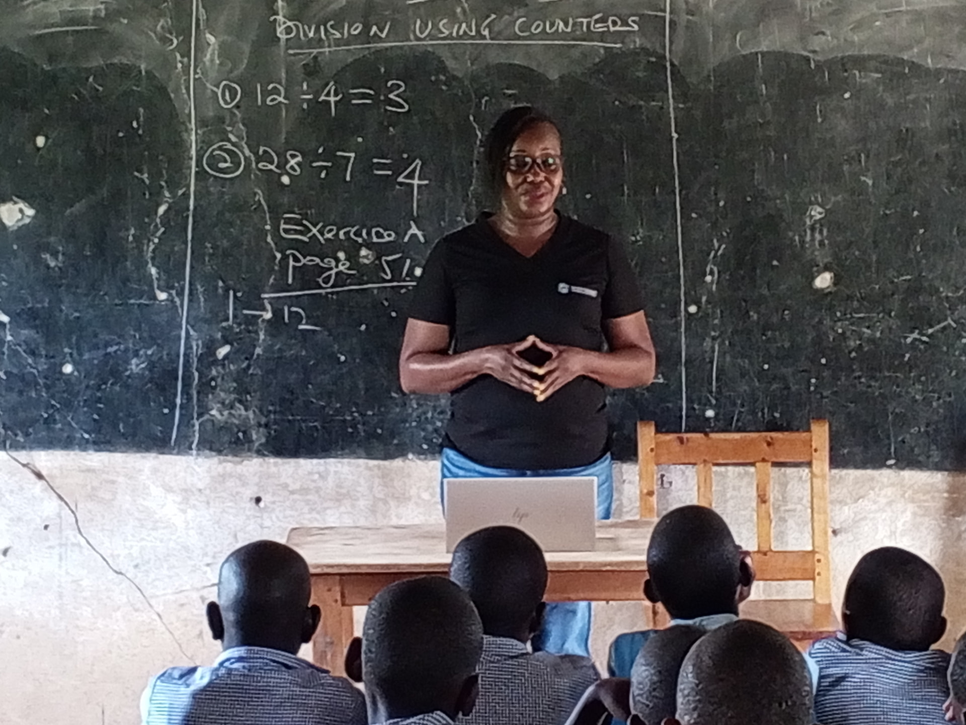 A teacher leading a division lesson before a class of pupils in Makueni