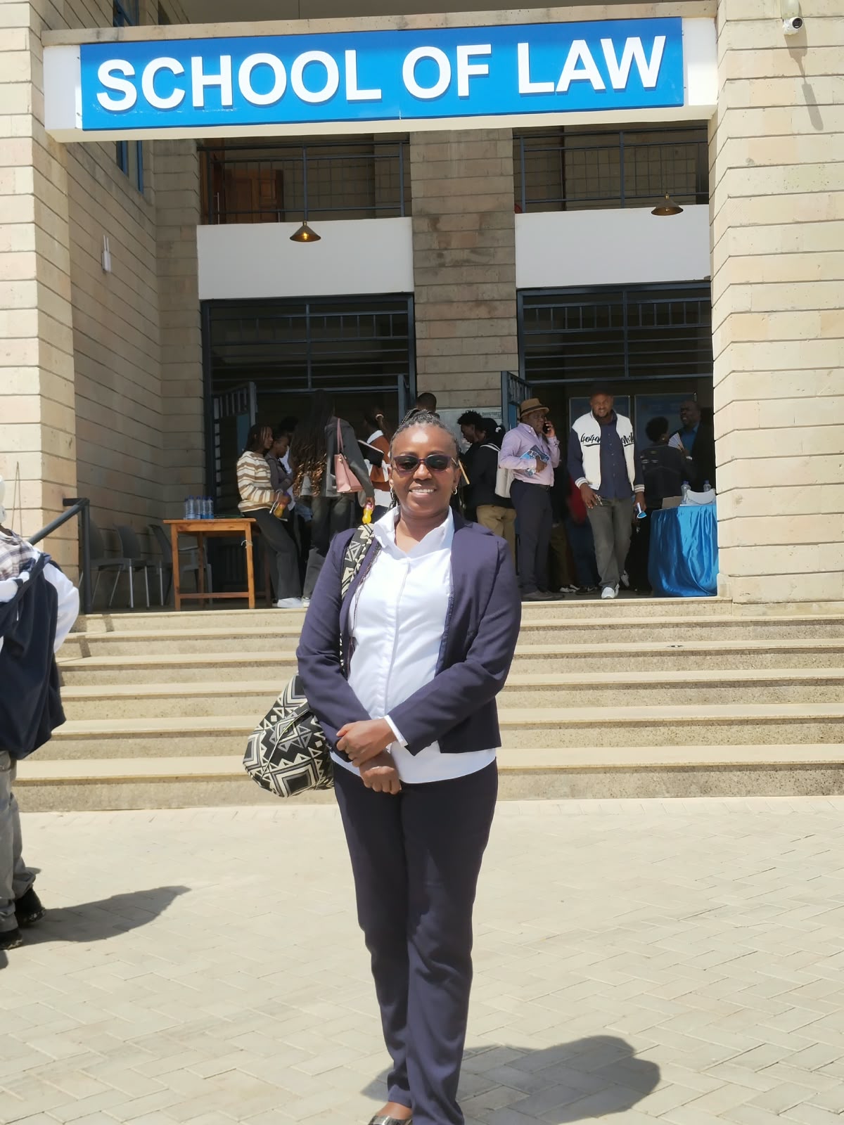 Consolata Katua standing outside the School of Law
